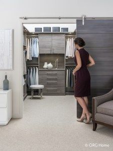 a woman standing in front of an open closet