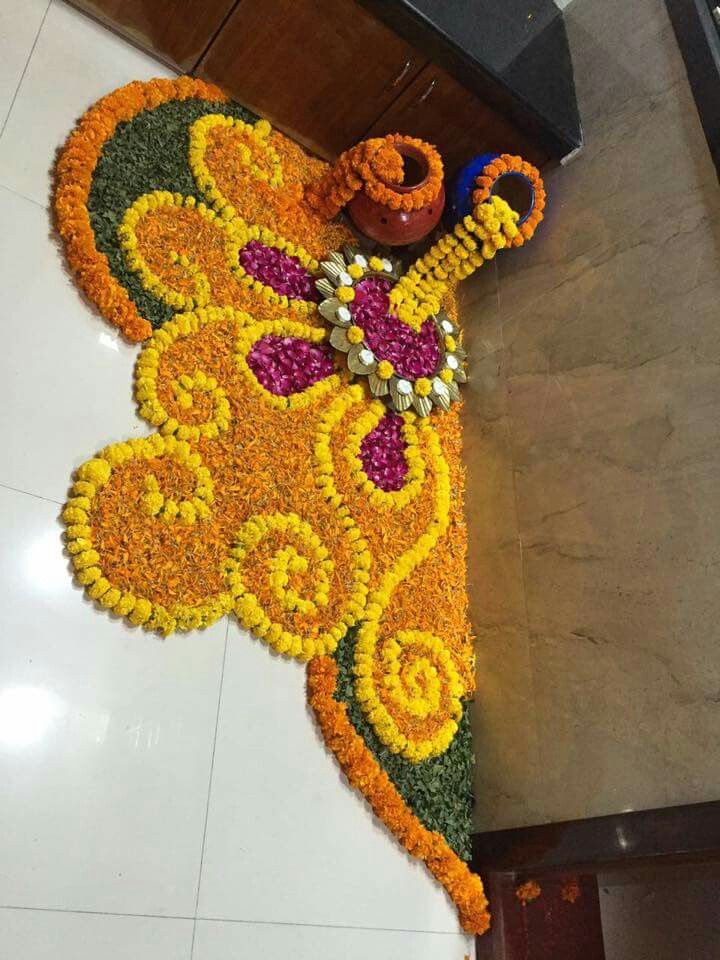 an intricately decorated floor in the shape of a butterfly with beads and flowers on it