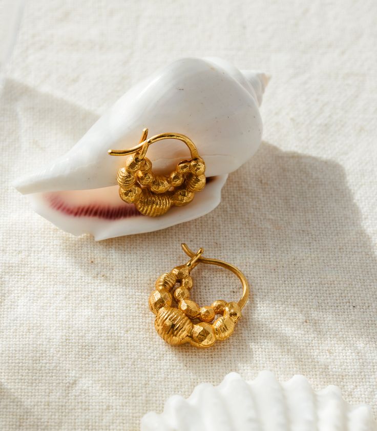 Captivate the room with the carefully embellished Aira Earrings. Handcrafted in gold filigree, a meticulous and rare technique perfected by the plateros of Ilocos Sur, every heirloom carries the proud story of our pre-colonial heritage and of fine Filipino craftsmanship. It can take 2 to 3 days to craft a pair of earrings. About the Craftmanship: The artistry of gold filigree craftsmanship has been practiced by native plateros for centuries. The platero begins by melting blocks of gold or silver Yellow Gold Brass Hoop Earrings With Intricate Design, Vintage 22k Gold Earrings, Yellow Gold Filigree Hoop Earrings In Brass, Gold Brass Plug Earrings With Intricate Design, Ornate Gold Brass Hoop Earrings, Ceremonial Gold Single Earring, Ceremonial Single Gold Earring, Single Gold Earring For Ceremonial Occasions, Handmade Baroque Gold Jewelry