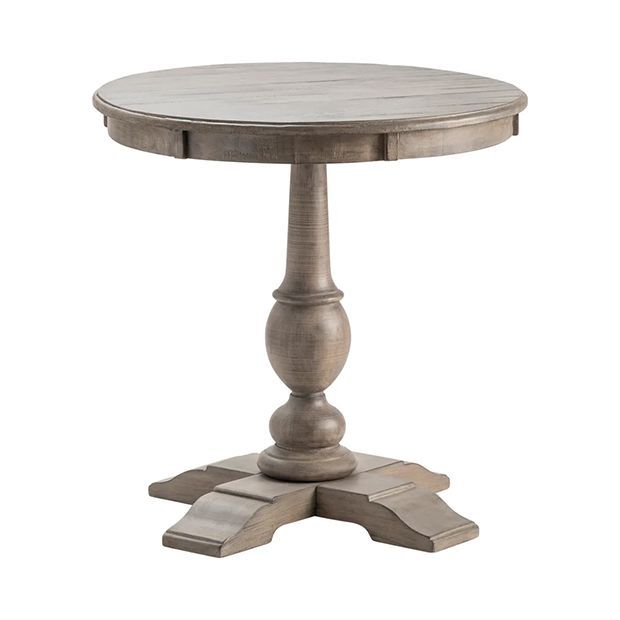 a round wooden table with two pedestals on the top and one leg raised up