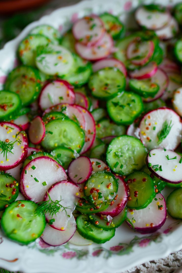 cucumber and radishes with herbs on a white plate, ready to be eaten