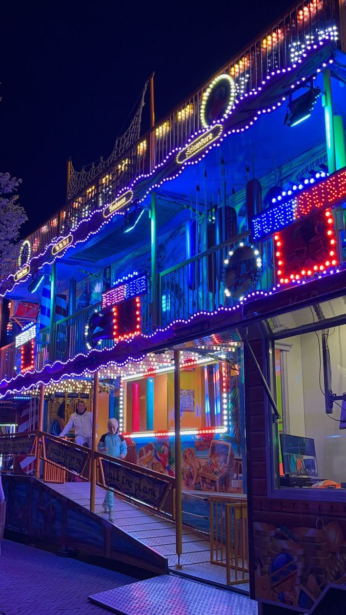 brightly lit buildings on a street at night