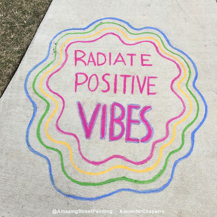 a sidewalk with chalk writing on it that says, radiate positive vibes