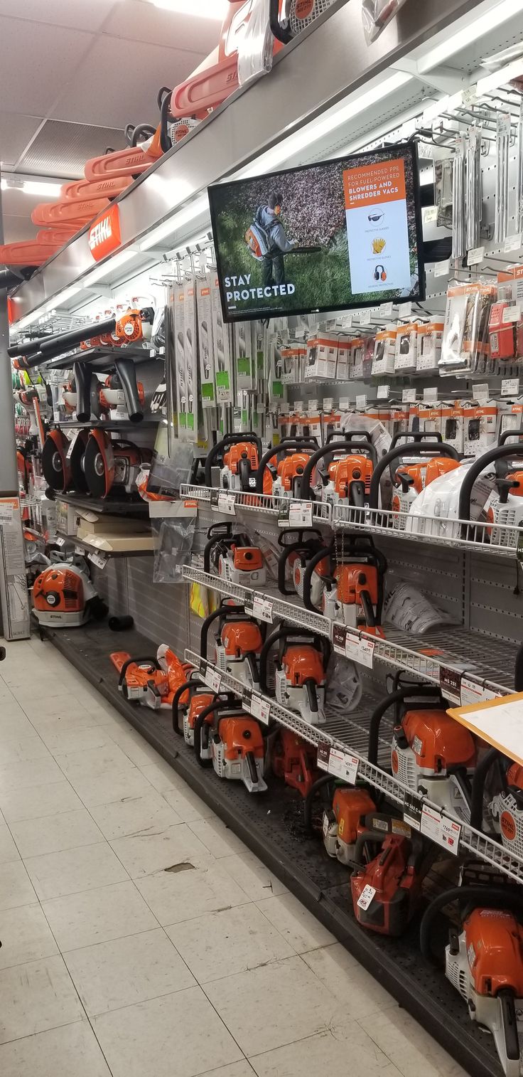 an orange and black display in a store with lots of different tools on it's shelves