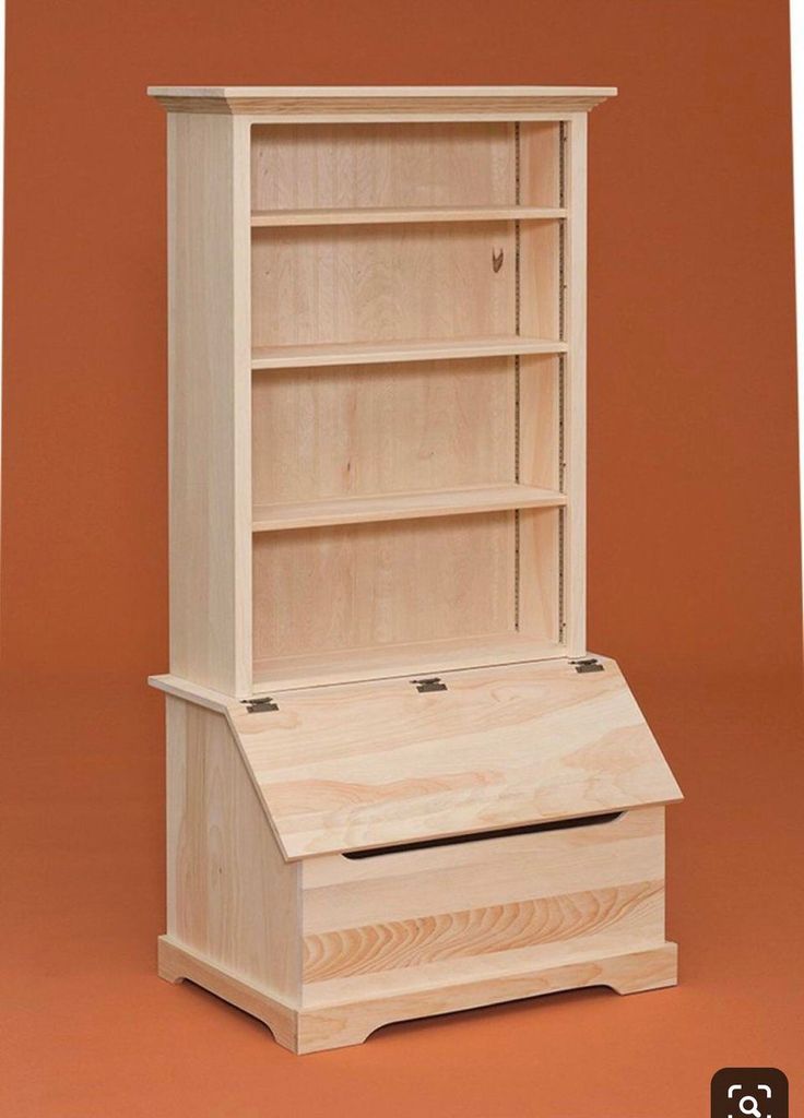 a wooden bookcase sitting on top of a red floor