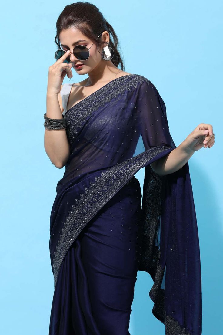 Product Features: Color: Navy Blue Fabric: Art Silk Work: Stone Embroidered Saree Length: 5.5 Meter Blouse Length: 0.80 Meter Style: Traditional Occasion: Festive Wash Care: Dry Clean Blouse Disclaimer: The last image gives a detailed look of the blouse piece that comes with this saree (The model is wearing a blouse from our in-house wardrobe) Disclaimer: There will be slight difference in digital to actual image White Full Sleeve Blouse, Blue Plain Saree, Plain Saree With Designer Blouse, Saree With Designer Blouse, Christian Bridal Saree, Navy Blue Saree, One Minute Saree, Full Sleeve Blouse, Indian Designer Sarees