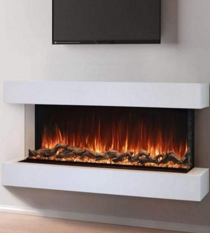 an electric fireplace in a living room with a flat screen tv on the wall above it