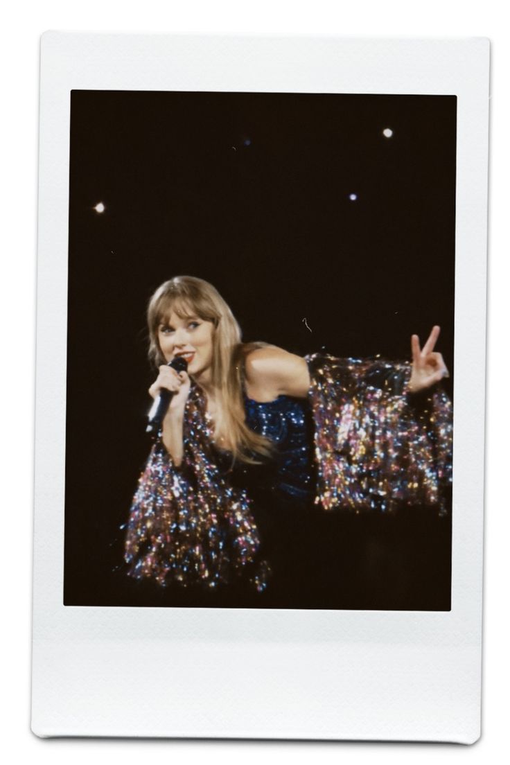 an old photo of a woman in sequins holding a microphone and making the peace sign