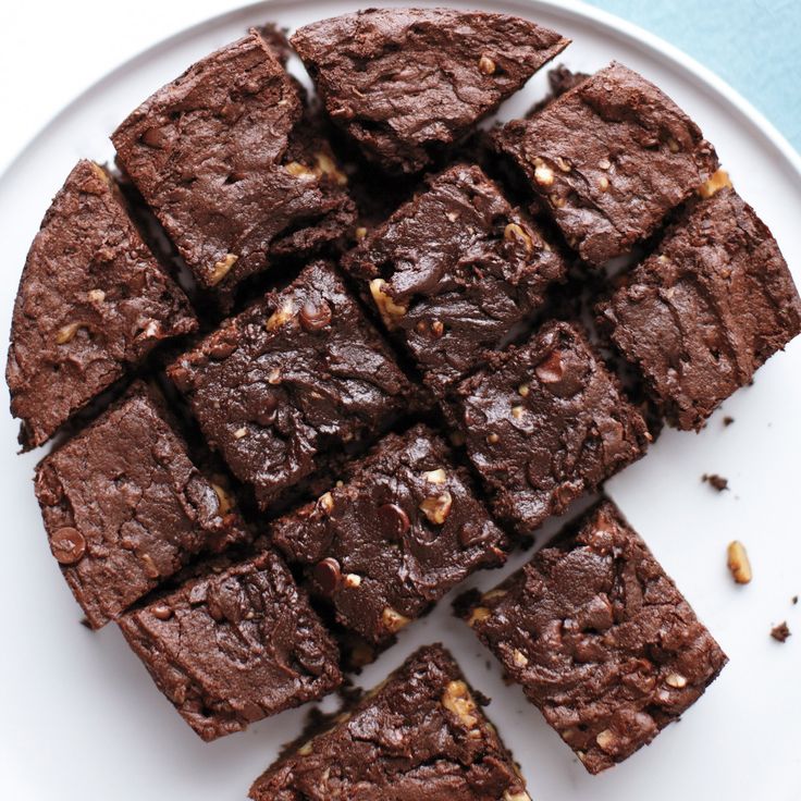 chocolate brownies cut into squares on a white plate