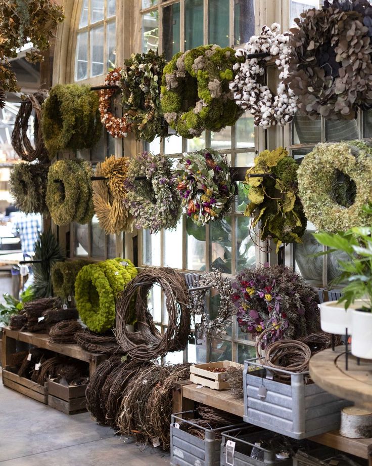 wreaths hanging on the wall in a store