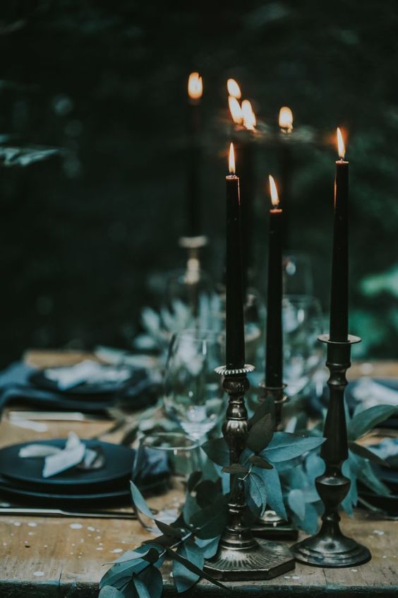 the table is set with candles and place settings