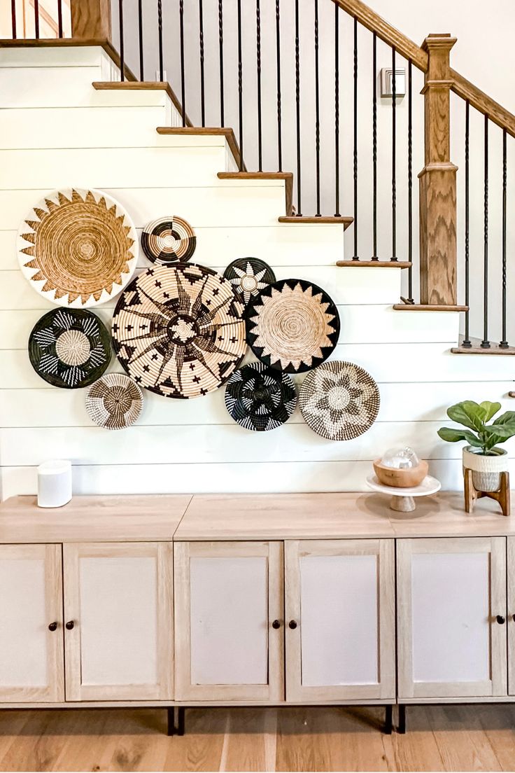 Boho woven baskets accent wall on shiplap staircase Baskets On Staircase Wall, Basket Walls Boho Kitchen, Wicker Basket Wall Art Stairs, Farmhouse Basket Walls Woven, Basket Walls Boho Living Room, Shiplap Staircase, Basket Walls Boho, Woven Wall Basket Decor, Stairs Wall Decor