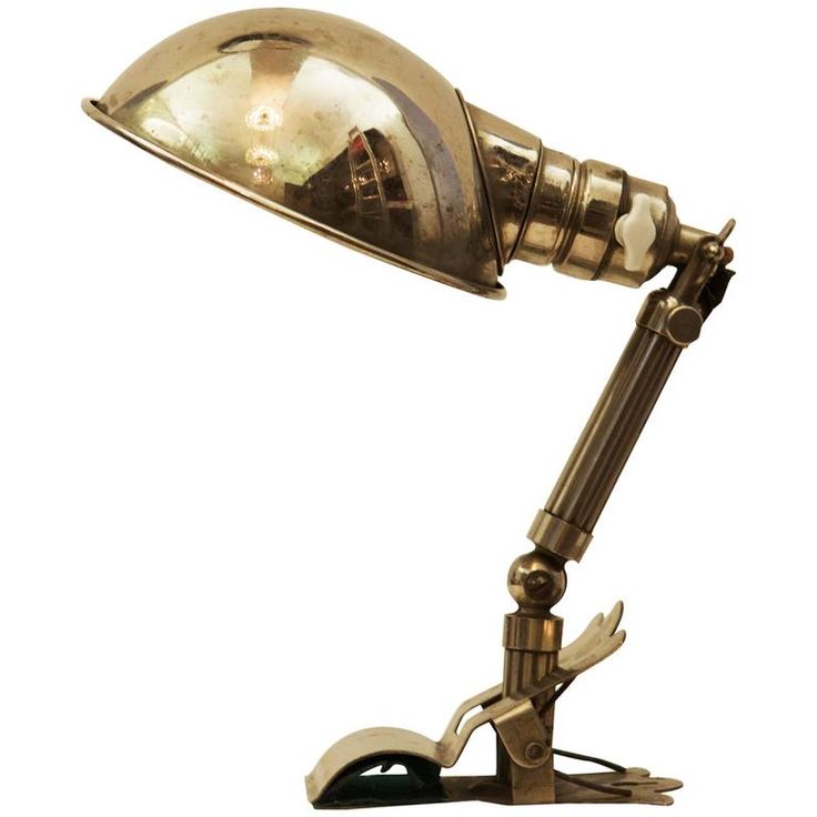 an antique brass desk lamp with a mouse on the bottom and one light turned on