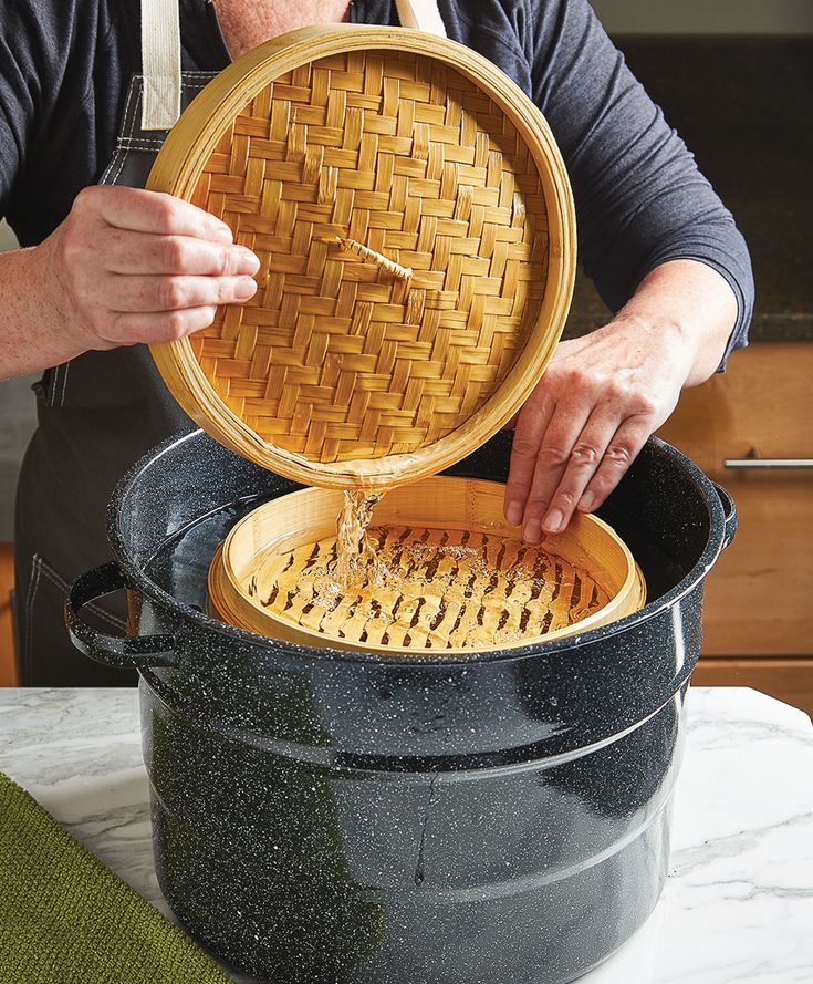 a man is pouring something into a large pot