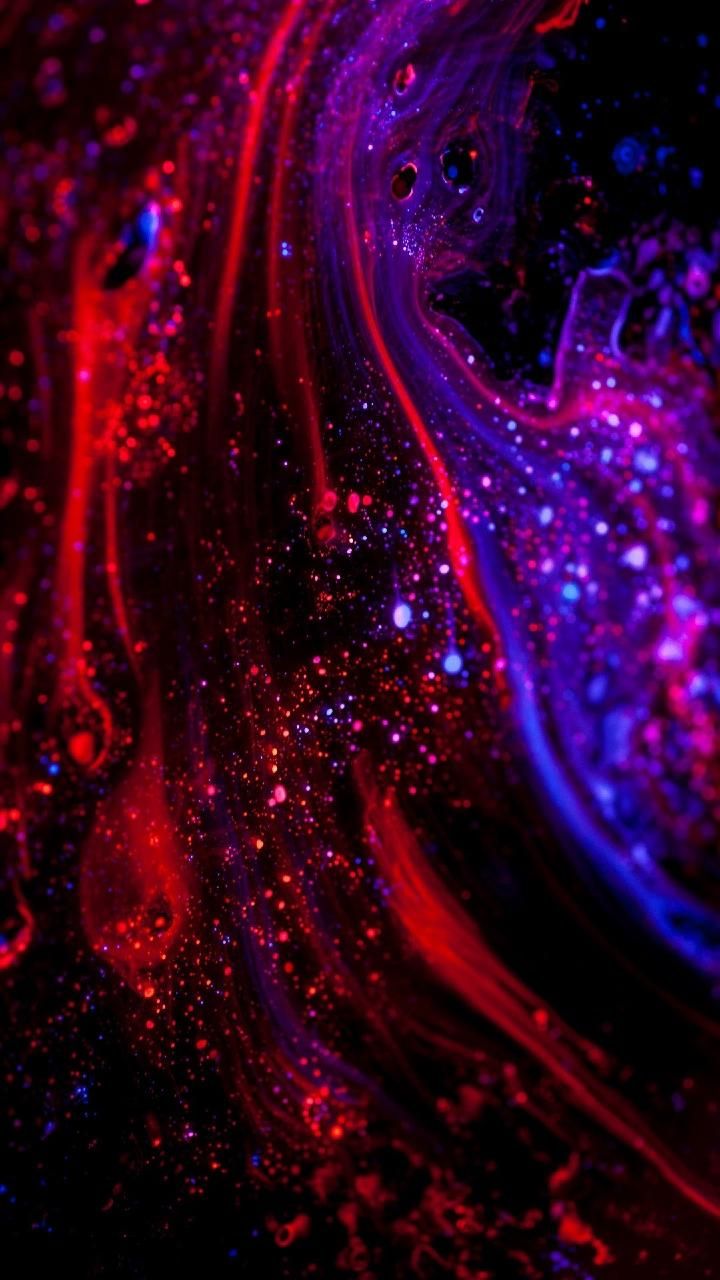 an abstract painting with red and blue colors on black background, which looks like liquid or glitter