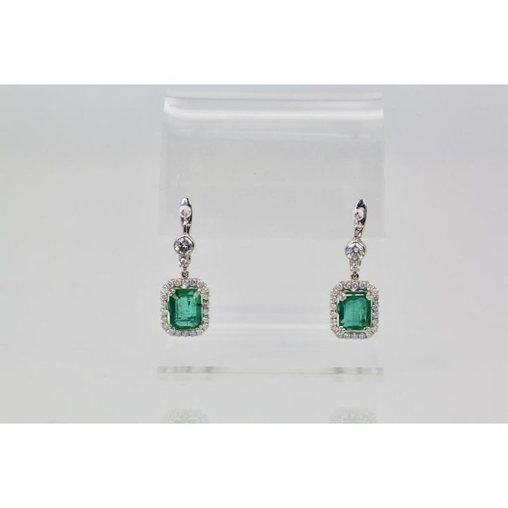 This is part of Chairish’s Fine Jewelry assortment.  Emerald Diamond 18K Earrings  These Emerald earrings are a match to the Emerald ring listed and are a gorgeous shade of green transparent and lively. I do not see any inclusions whatsoever. Those of you who have Emeralds know that to match an Emerald is very difficult and these match the ring listed perfectly. These were made by my bench jeweler for me and to the naked eye you can not see any imperfections. Of course magnified you see the natural inclusions but with the naked eye they are absolutely beautiful. These earrings have 4.65 carats of Emeralds each stone 2.32 + 2.33 carats the Diamonds weigh 2.40 carats with a .020 Diamond on top. Stones 7.09 x 8.53 with Diamond surround 10.82 x 13.85 the drop is 20mm. Emerald Cut Green Sterling Silver Earrings, Formal Green Diamond Gemstone Earrings, Green Diamond Earrings With 17 Jewels For Formal Events, Green Diamond Earrings With 17 Jewels For Formal Occasions, Formal Green Gemstone Diamond Earrings, Green Diamond Earrings For Formal Occasions, Classic Green Diamond Drop Earrings, Green Diamond Drop Earrings, Green Diamond Earrings For Evening