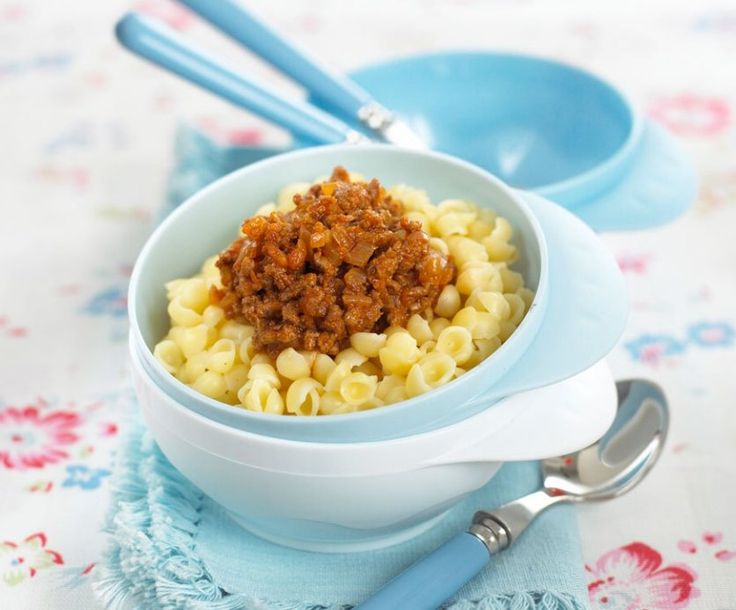 a bowl filled with macaroni and cheese on top of a table