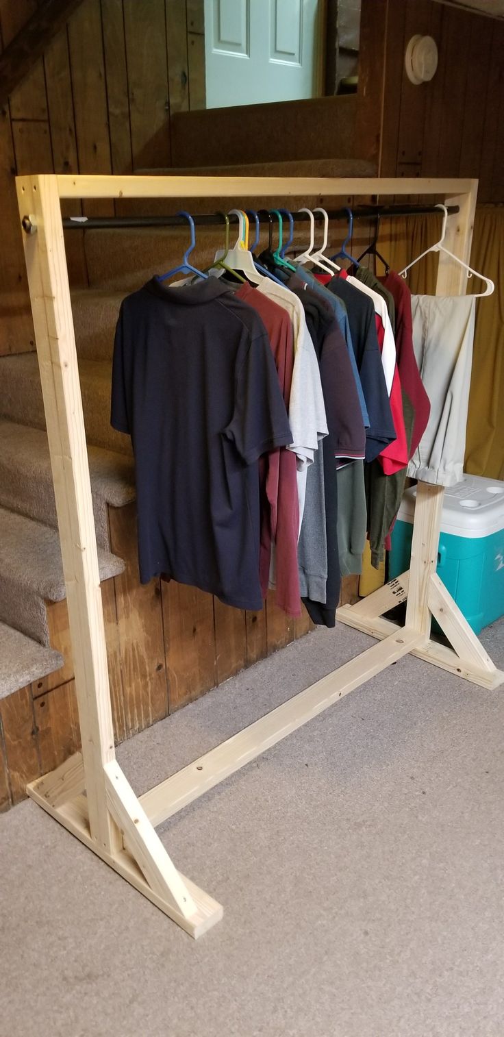 clothes hanging on rail in front of stairs