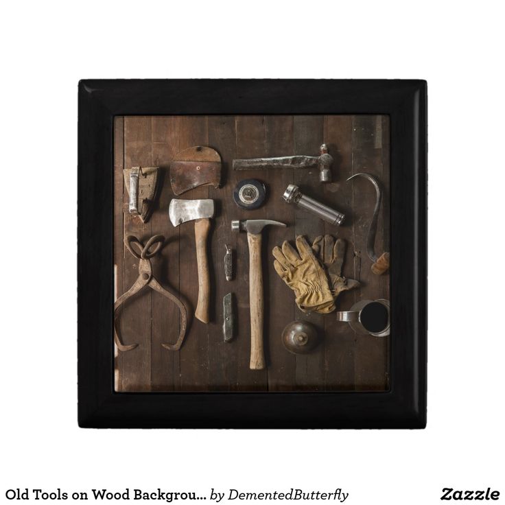 an old tool is displayed in a shadow box on a wooden table with other tools