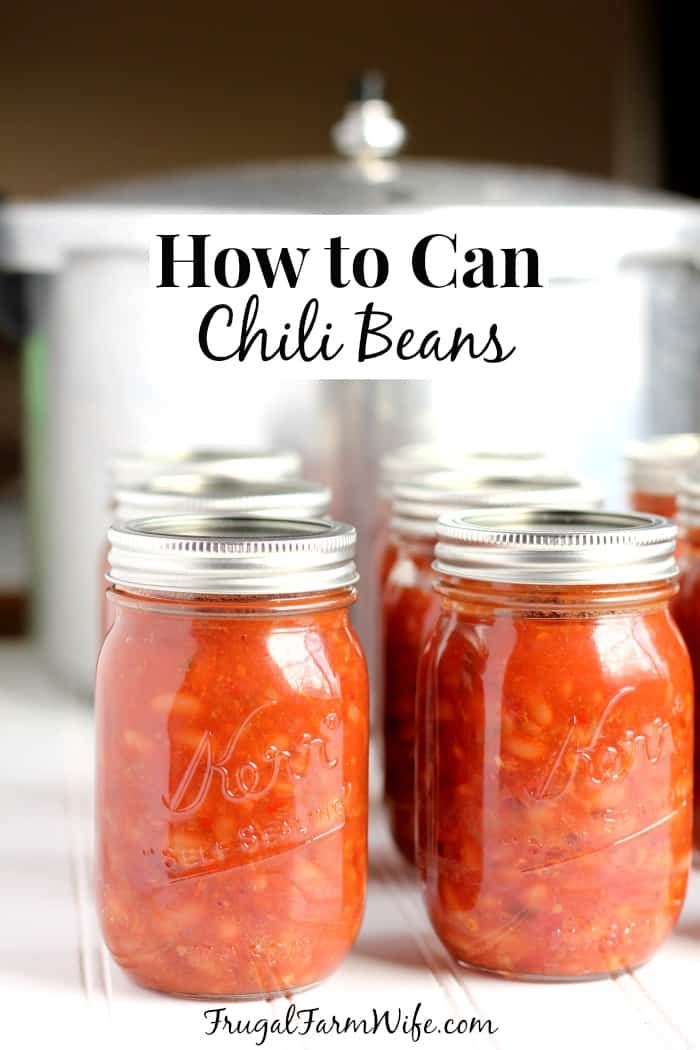 four jars filled with chili beans sitting on top of a counter