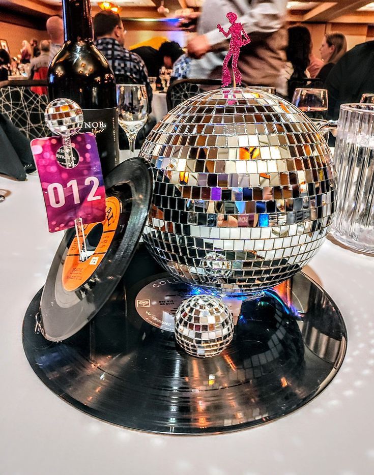 a disco ball sitting on top of a black plate