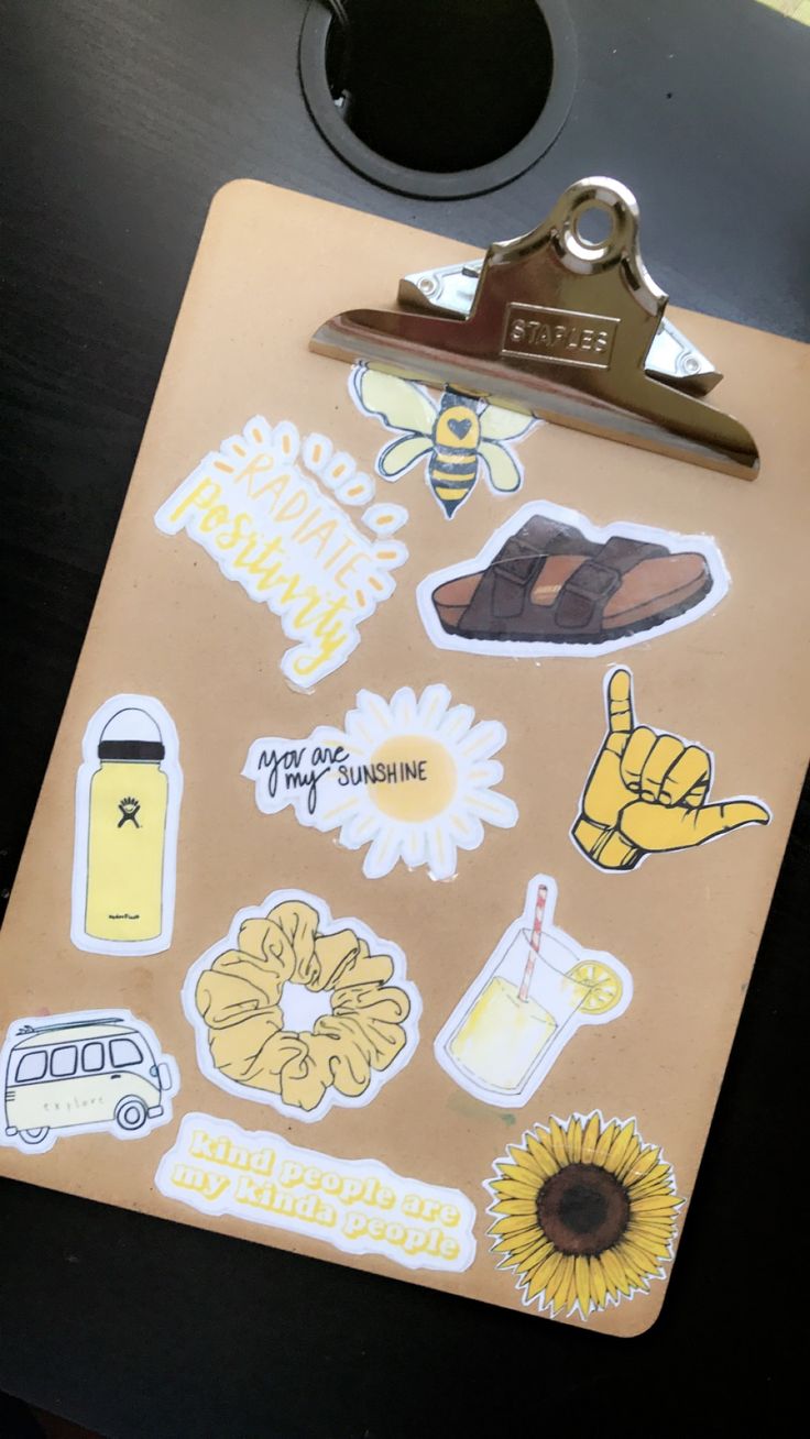 a clipboard with various stickers on it