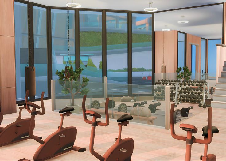 there are many exercise bikes in the room with large windows on either side of the wall