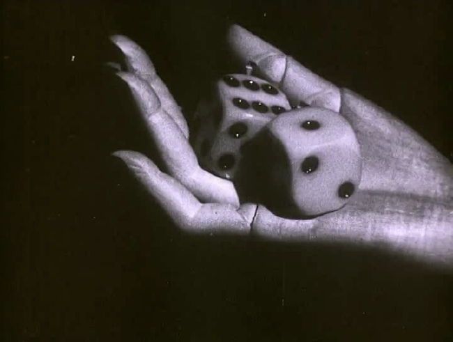 two dices in the palm of a person's hand, black and white