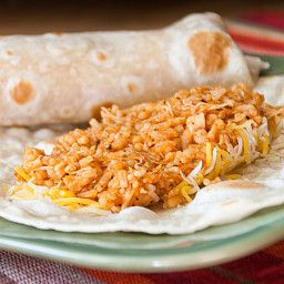 two burritos sitting on top of a green plate