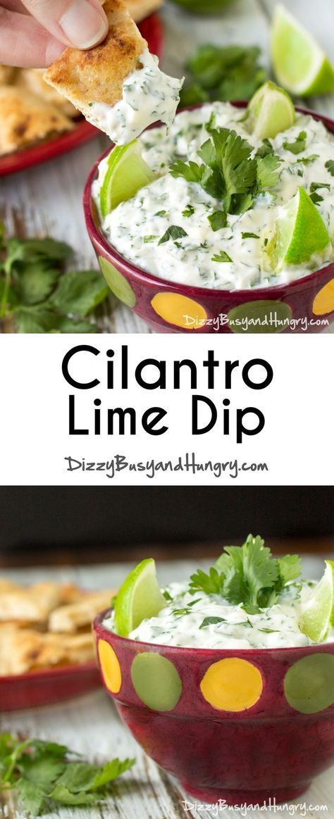 a hand dipping cilantro lime dip into a bowl with pita chips and garnishes