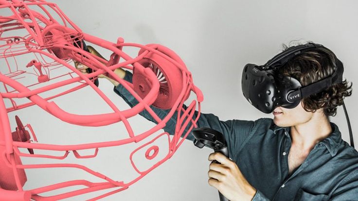 a young man wearing headphones and holding a device in front of a large pink object