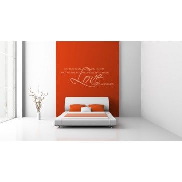 a bedroom with an orange wall and white furniture