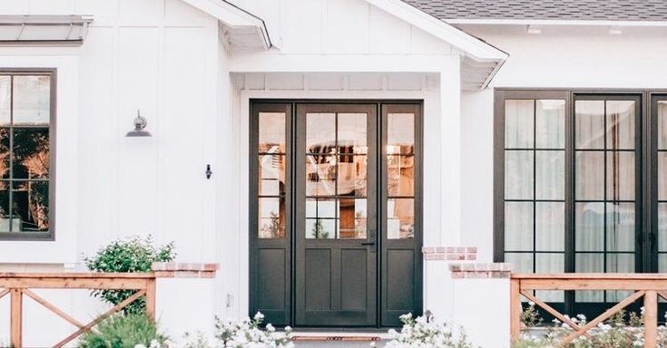 a white house with black doors and windows