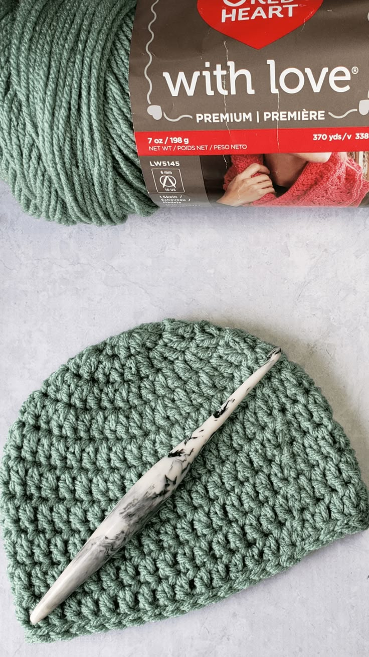 a crochet hat with yarn next to it