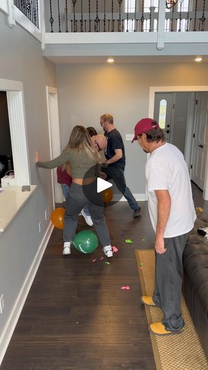 a group of people standing in a living room