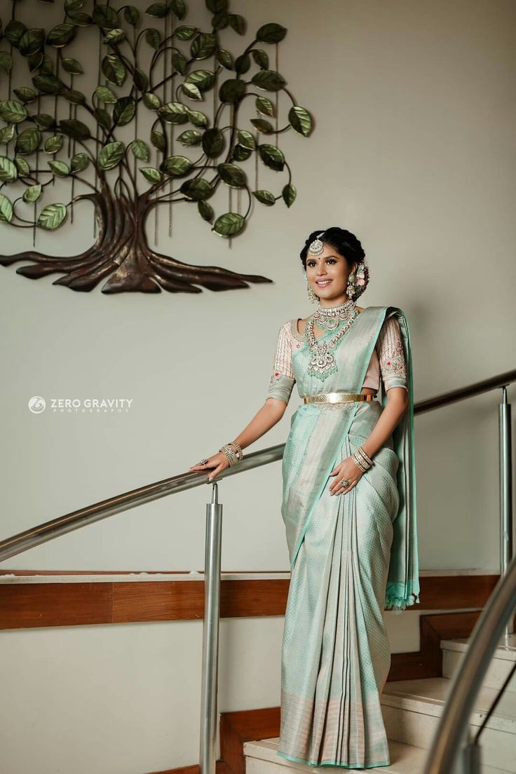 a woman in a sari standing on stairs