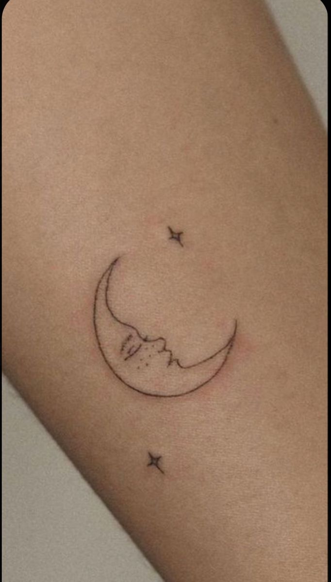 a small crescent moon and stars tattoo on the arm