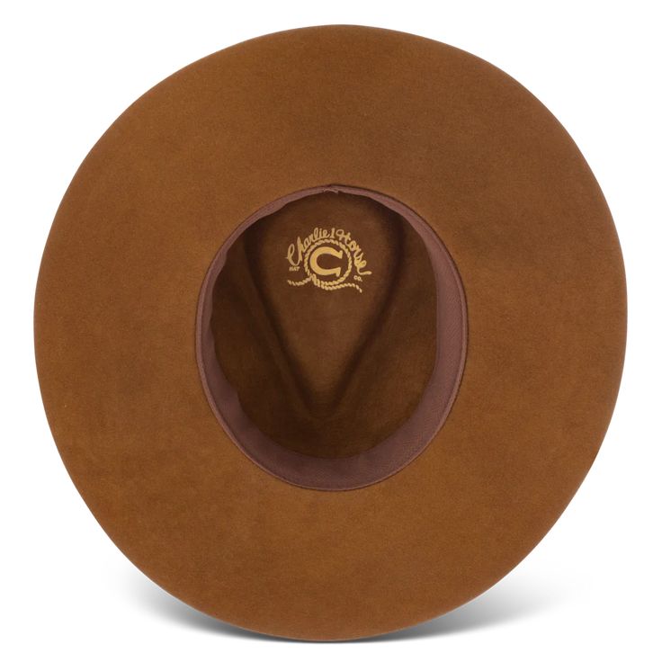 Charlie 1 Horse CWGYPS-403611 Gypsy Acorn Wool Hat Imbued with a wanderer’s soul and made for the open road, the Gypsy in Acorn is a delightful wool hat with a 3 3/4" pinch-front crown and a 3 3/4" floppy downturned brim. The beaded hatband features a classic Native-American-inspired pattern in blues, reds, and golds, with a lone feather tucked in for good measure. An off-center Charlie 1 Horse brand logo on the crown signals the hat’s point of origin. Part of our Wanted Collection, the Gypsy wa Brown Fedora For Rodeo In Fall, Fall Hats With Flat Crown, Fall Flat Crown Hat One Size, Brown Felt Hat For Rodeo In Fall, Brown Felt Hat For Fall Rodeo, Fall Rodeo Brown Felt Hat, Brown Felt Fedora With Curved Brim, Brown Winter Hat For Rodeo, Brown Felt Hat With Flat Crown For Fall