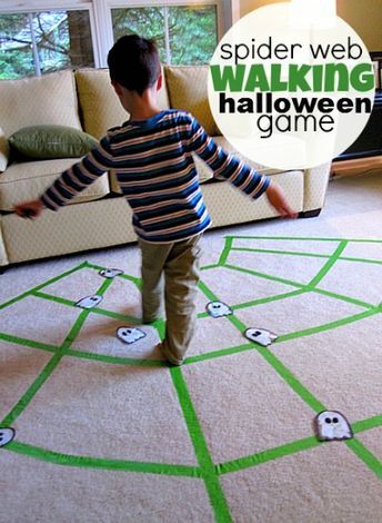 a young boy standing on top of a rug in front of a couch with the words spider web walking game