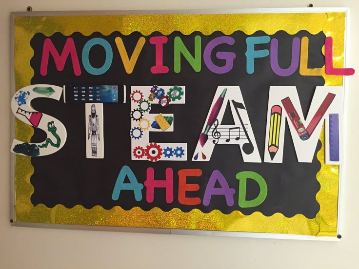 a sign that says moving full steam ahead on the side of a wall in a classroom