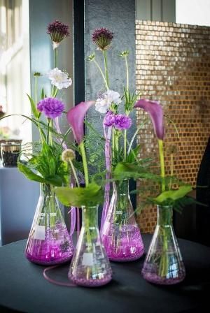 three vases filled with purple and white flowers