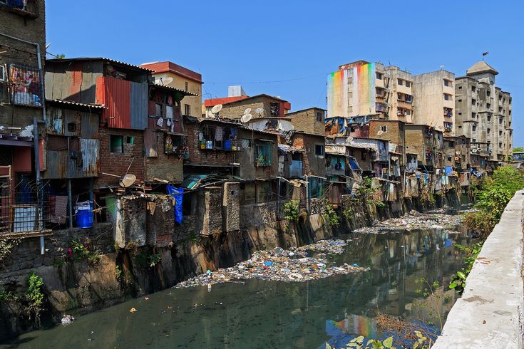 a river running through a city with lots of buildings on both sides and laundry hanging out to dry