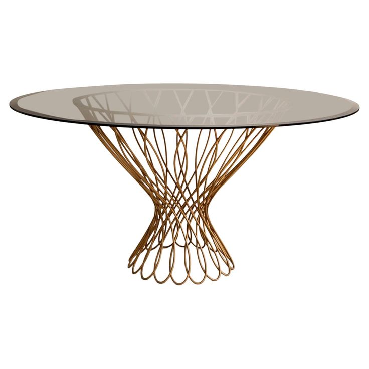 an oval glass table with gold metal legs