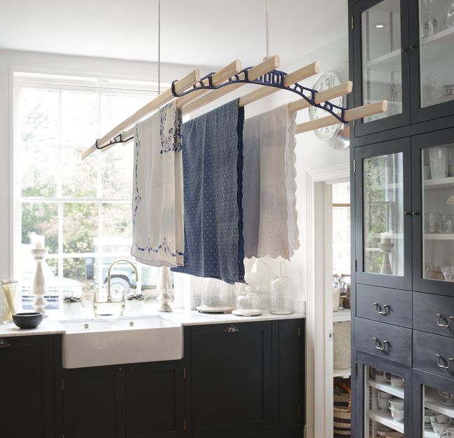 a kitchen with some towels hanging on a rack in front of a sink and cabinets