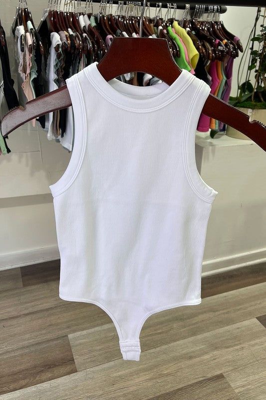 The White Tank Rib Bodysuit is perfect for a night out. Crafted with a ribbed fabric and cut for a body-hugging fit, this bodysuit will keep you looking stylish and feeling comfortable all night long. The tank ribbed design fits snug to your figure, making a sleek statement. Complete your look with a pair of jeans or a skirt for a night of fun. Fabric & fit: 92% nylon 8% spandex Model is wearing size Small. Stretch Ribbed Bodysuit For Night Out, Ribbed Bodycon Tops For Summer, Summer Ribbed Bodycon Tops, Ribbed Bodycon Summer Tops, Fitted Ribbed Bodysuit For Night Out, Chic Ribbed High Stretch Bodysuit, Ribbed Bodycon Tank Top For Summer, Ribbed Bodysuit For Night Out In Spring, Ribbed Bodysuit For Night Out