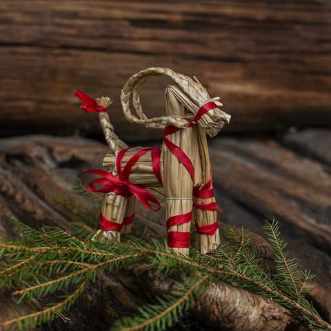 a small wooden dog with a red ribbon tied around it's neck and tail