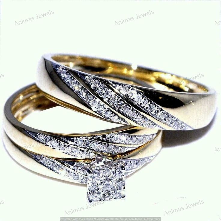 three wedding rings with diamonds on top and one diamond in the middle, all stacked together