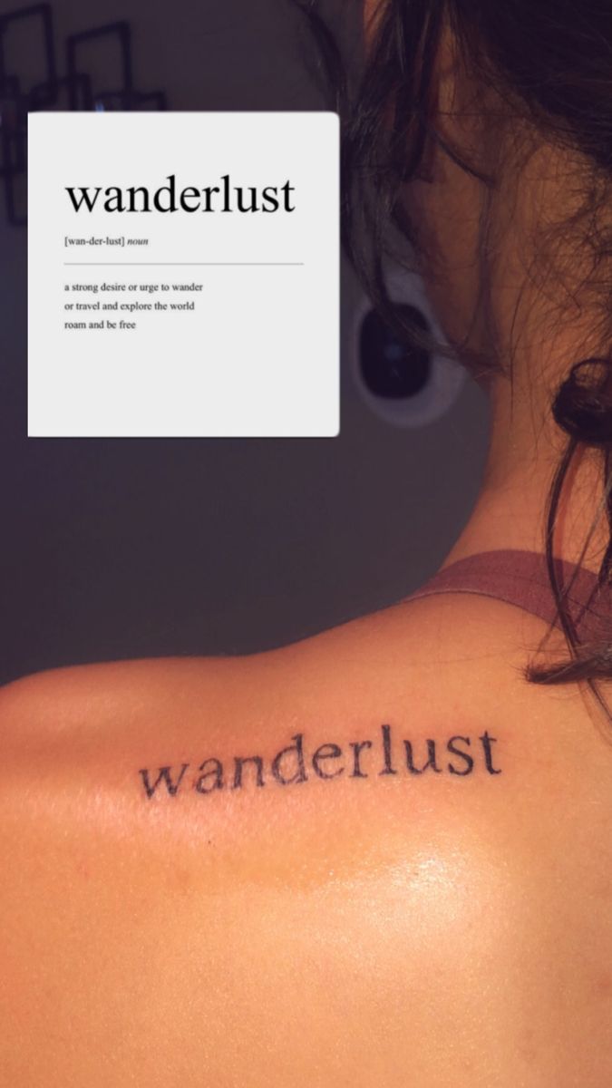 the back of a woman's shoulder with words written on it