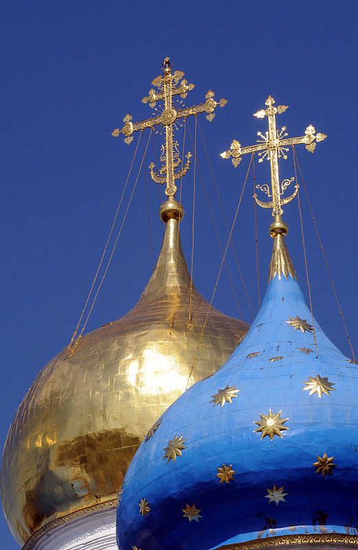 two gold and blue domes with crosses on them