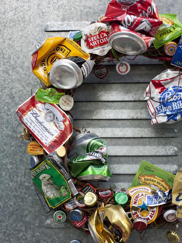 a wreath made out of beer cans and other assorted items sits on the ground